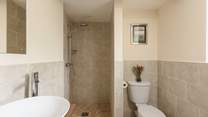 The en suite wet-room is modern and bright.