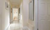 The light-filled  hallway leads to the bedrooms and bathroom. - Thumbnail Image
