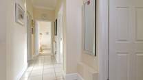 The light-filled  hallway leads to the bedrooms and bathroom.