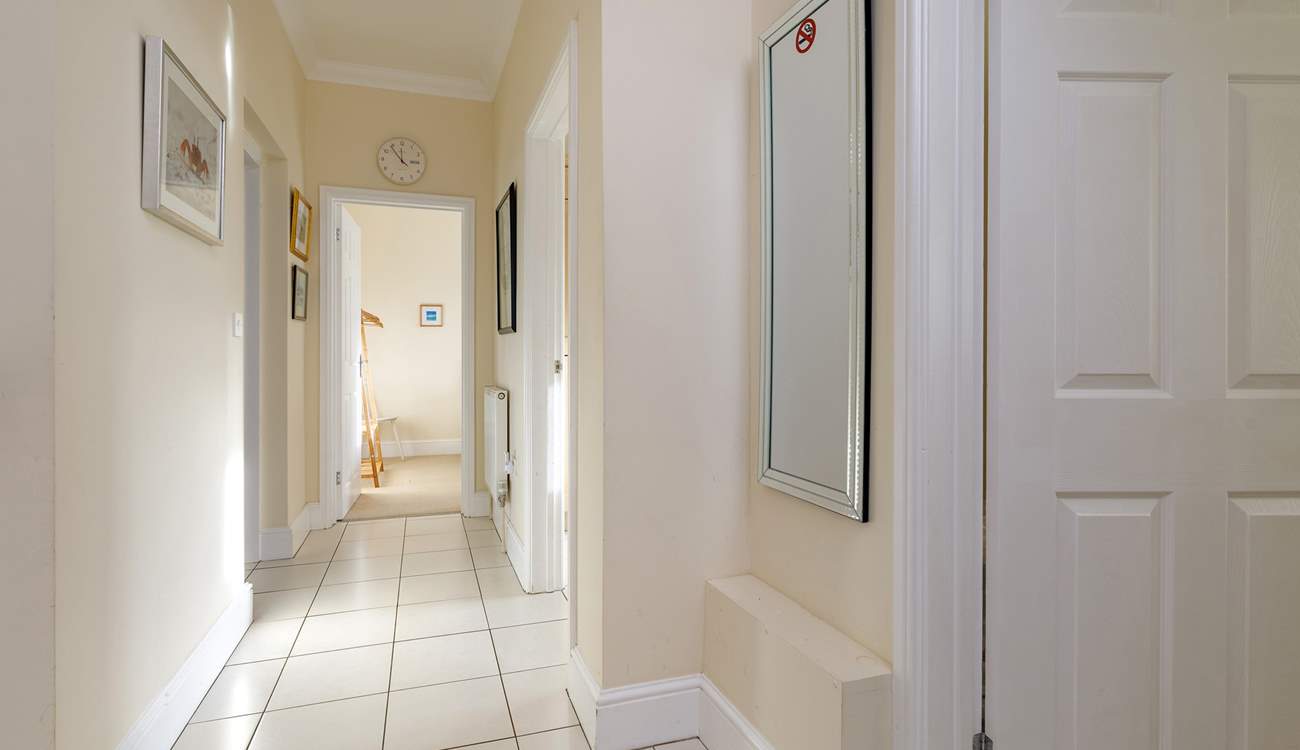 The light-filled  hallway leads to the bedrooms and bathroom.