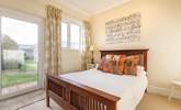 The ground floor double bedroom with a door leading to the communal garden. - Thumbnail Image