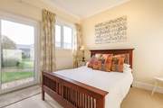 The ground floor double bedroom with a door leading to the communal garden.