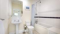 The family bathroom with bath and fitted shower.