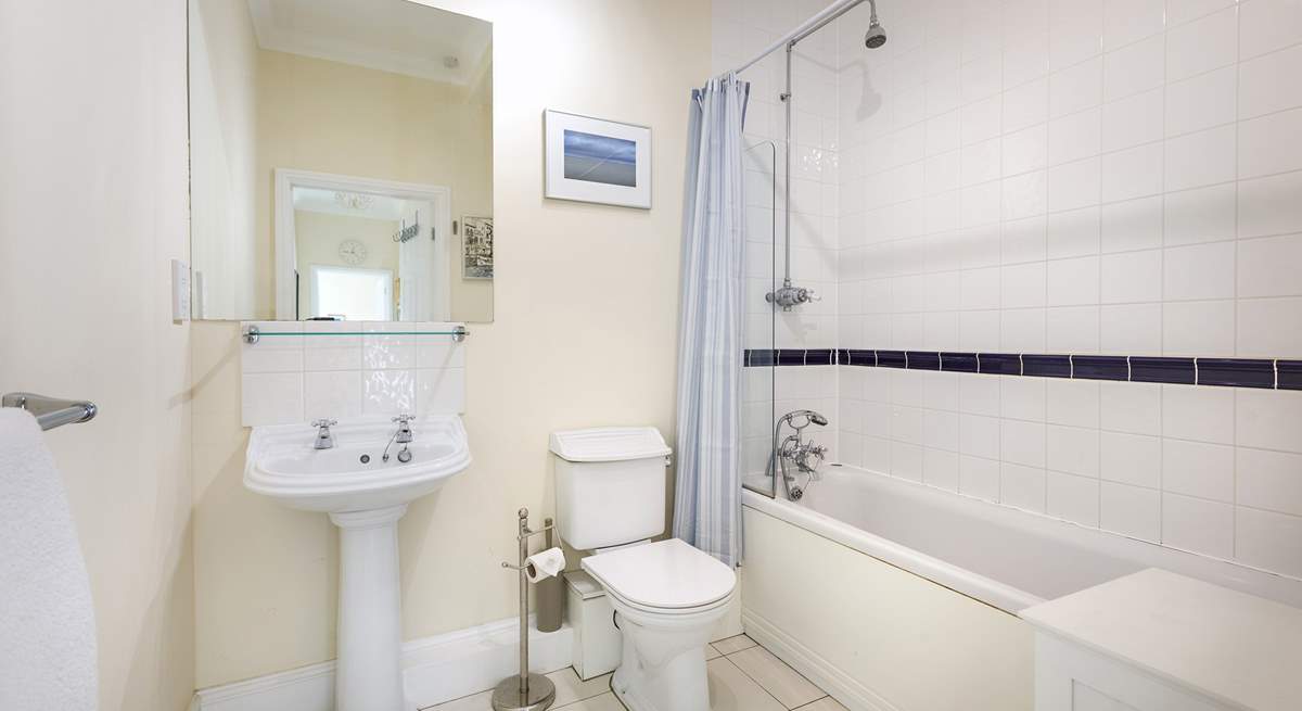 The family bathroom with bath and fitted shower.