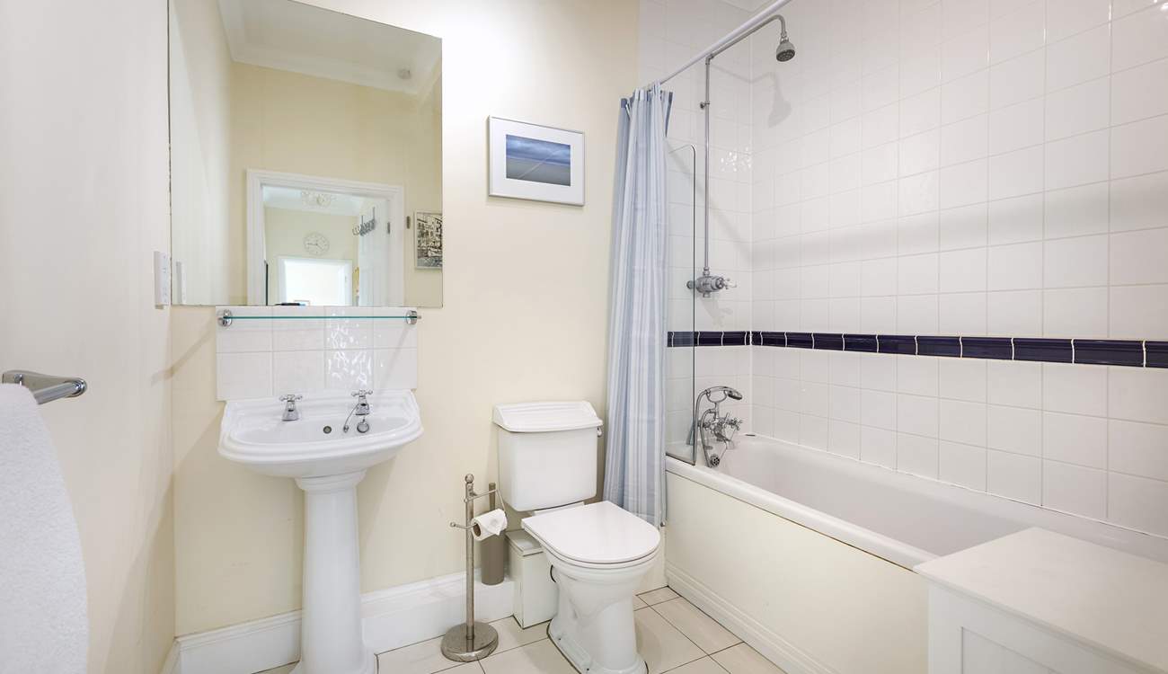 The family bathroom with bath and fitted shower.