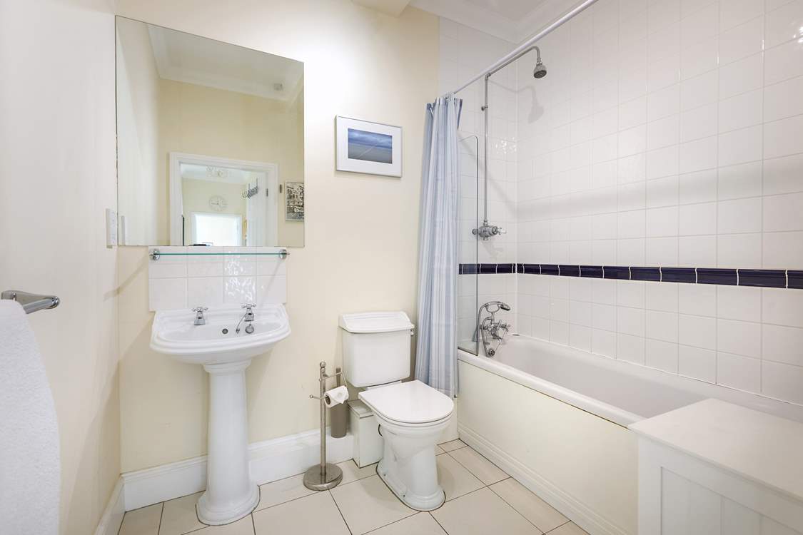 The family bathroom with bath and fitted shower.