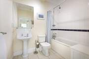 The family bathroom with bath and fitted shower.