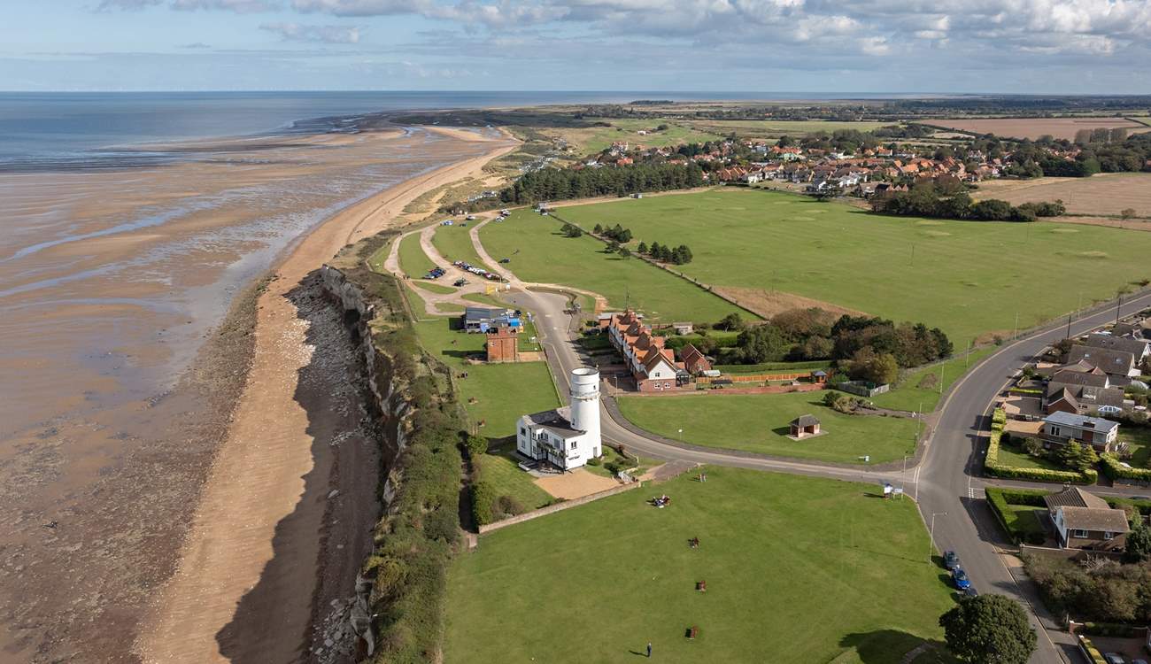 An aerial view of Hunstanton lighthouse and the changing tides of towards Old Hunstanton, minutes walk from Sandy Shores.