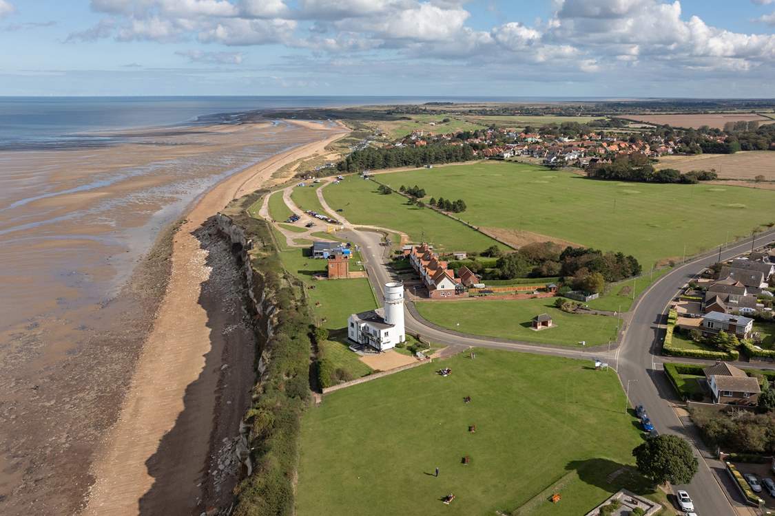 An aerial view of Hunstanton lighthouse and the changing tides of towards Old Hunstanton, minutes walk from Sandy Shores.