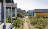 The gorgeous pastel shades of beach huts are moment from the apartment  greeted by the soft sandy beaches and shoreline. - Thumbnail Image