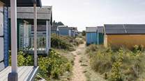 The gorgeous pastel shades of beach huts are moment from the apartment  greeted by the soft sandy beaches and shoreline.