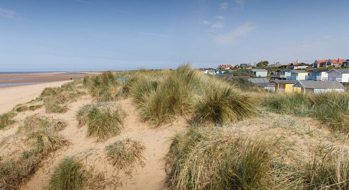A gentle stroll to the colourful beach huts and soft sandy dunes is a delight.