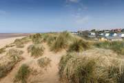 A gentle stroll to the colourful beach huts and soft sandy dunes is a delight.