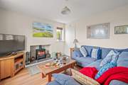 The living-room boasts a large Smart TV. Perfect for those movie nights cuddled up in front of the wood-burner.