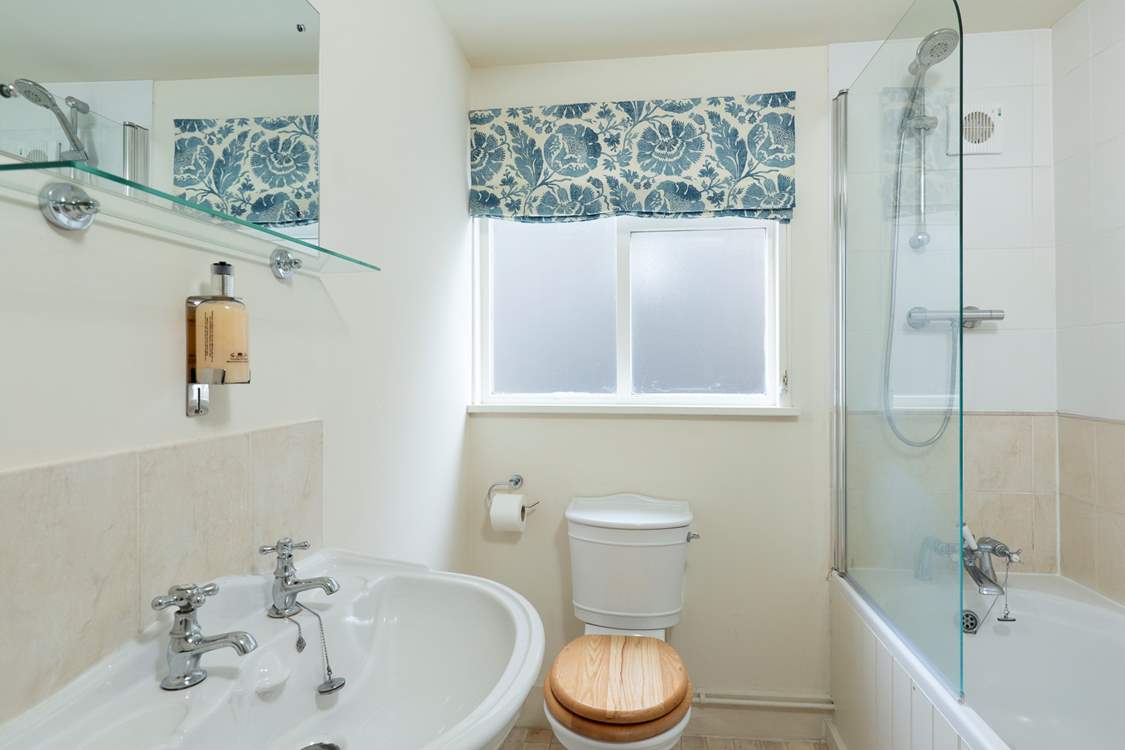 The family bathroom with bath and fitted shower.