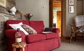 Whether planning for the next day or recovering from the day's adventures, relax on this comfortable sofa. - Thumbnail Image