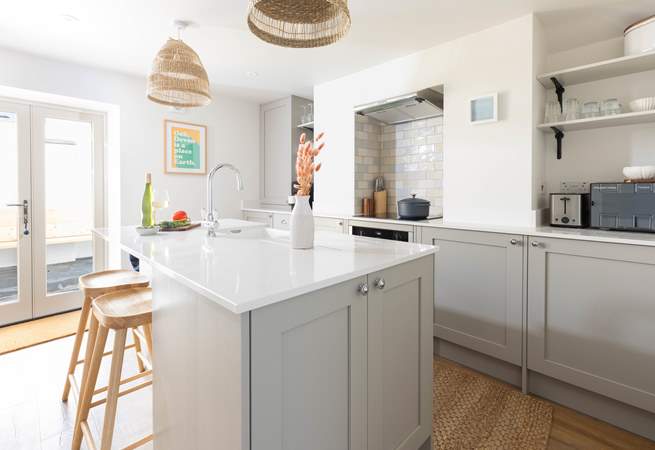 From the dining-area walk through to the modern fully equipped kitchen. On a sunny morning open the patio doors on to the courtyard.