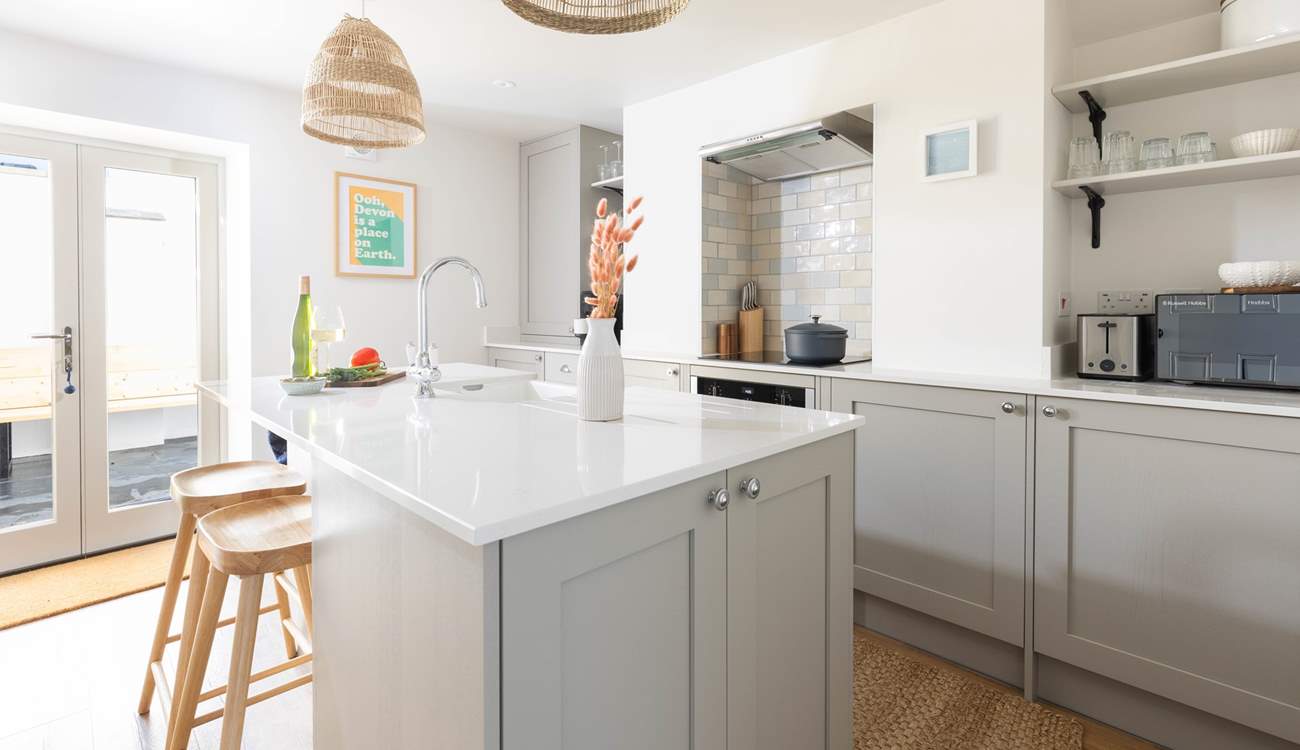 From the dining-area walk through to the modern fully equipped kitchen. On a sunny morning open the patio doors on to the courtyard.