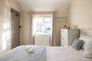 The sun shines in and bathes the bedroom in light.