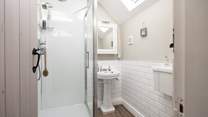 En suite shower-room with shower, WC and wash-basin to bedroom 1, calming and inviting. 