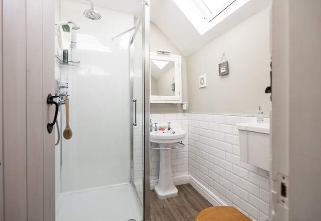 En suite shower-room with shower, WC and wash-basin to bedroom 1, calming and inviting. 