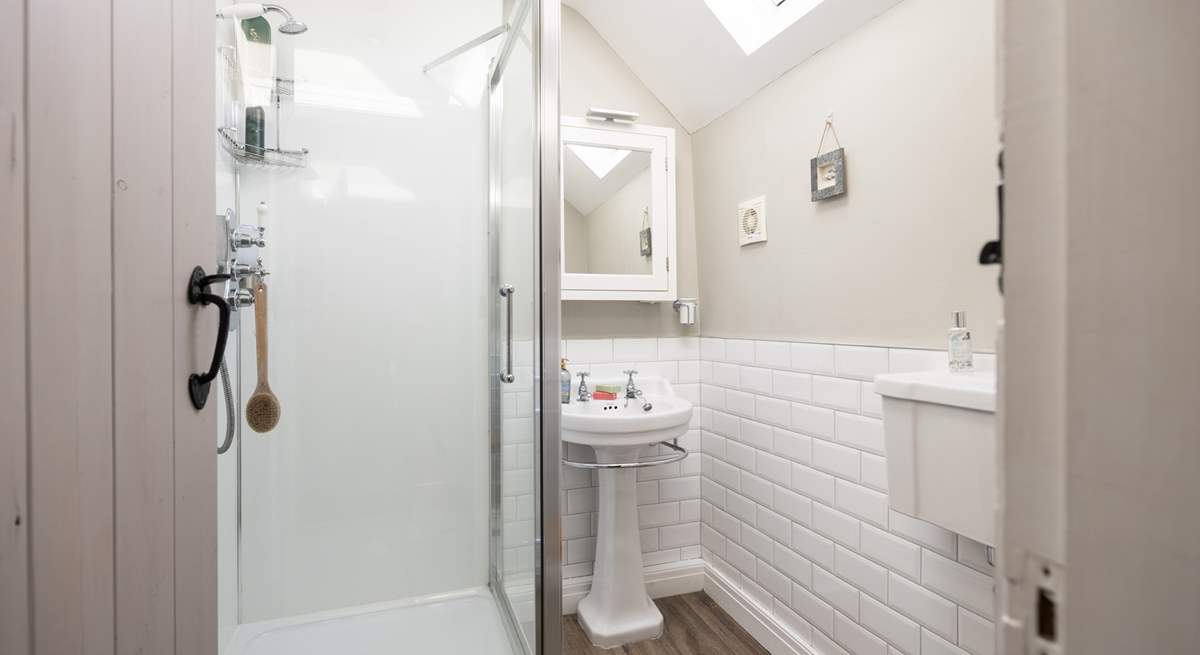 En suite shower-room with shower, WC and wash-basin to bedroom 1, calming and inviting. 