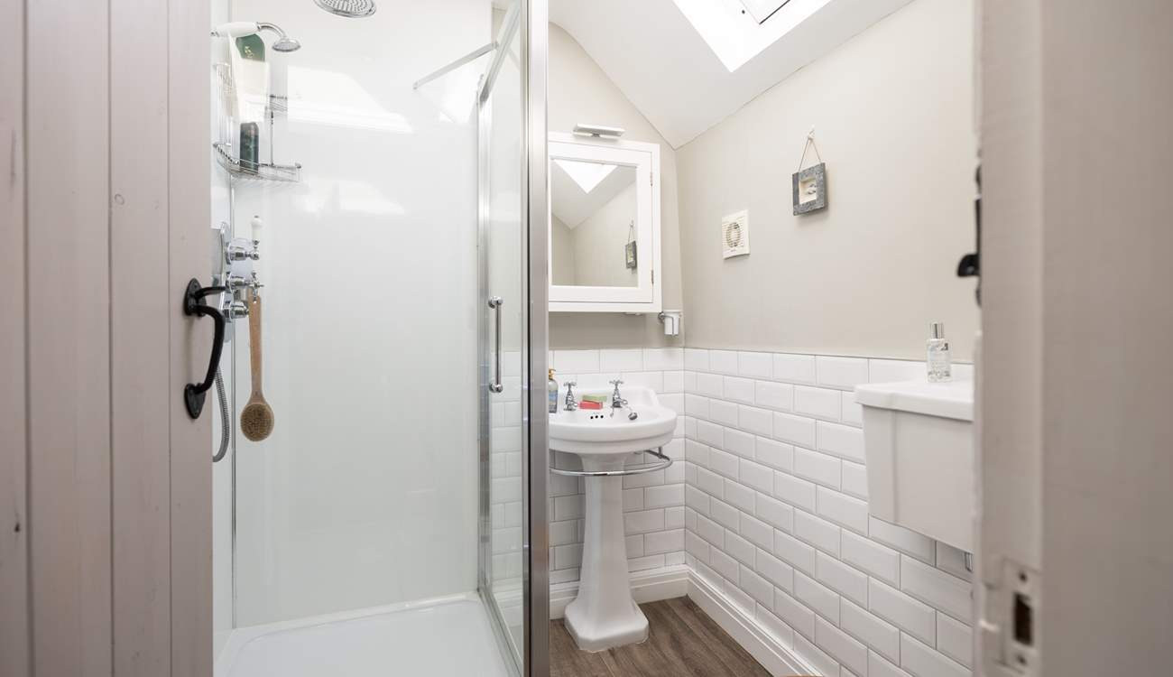 En suite shower-room with shower, WC and wash-basin to bedroom 1, calming and inviting. 
