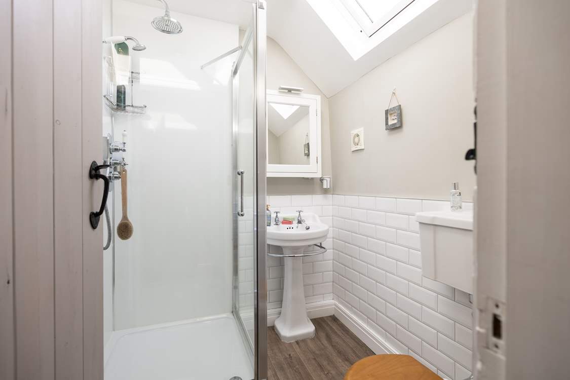 En suite shower-room with shower, WC and wash-basin to bedroom 1, calming and inviting.