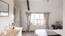 The main bedroom has a king-size double bed and a stylish en suite, relax in style. 