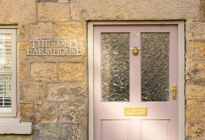 We just love the pink front door and cream stone façade. 
