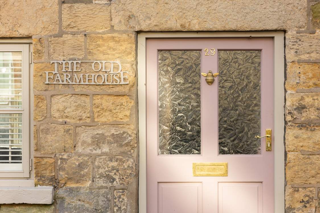 We just love the pink front door and cream stone façade.