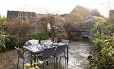 Al fresco dining is a pleasure surrounded by mature bushes and plants.  - Thumbnail Image