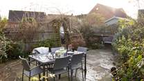 Al fresco dining is a pleasure surrounded by mature bushes and plants. 