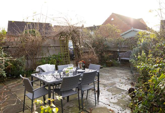 Al fresco dining is a pleasure surrounded by mature bushes and plants. 