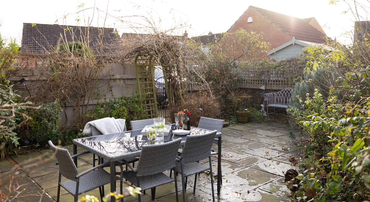 Al fresco dining is a pleasure surrounded by mature bushes and plants. 