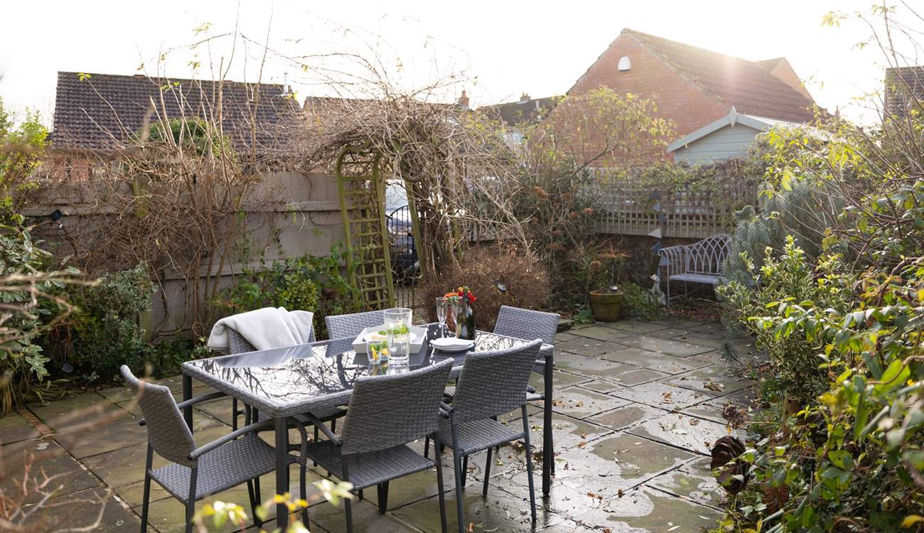 Al fresco dining is a pleasure surrounded by mature bushes and plants. 