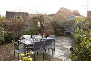Al fresco dining is a pleasure surrounded by mature bushes and plants.