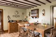 Admire the rustic plate rack and the traditional furniture.