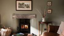 Cosy up in front of the wood-burner and relax (February 2026: Please note the wood-burner pictured here has recently been replaced with a slightly newer model). 