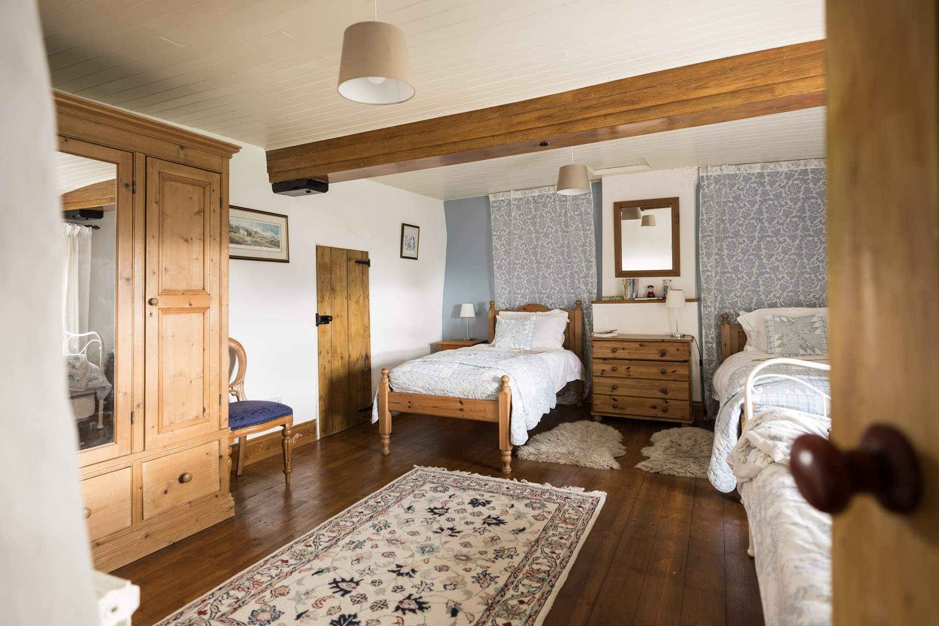 This spacious twin bedroom has a secret through the door...