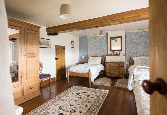 This spacious twin bedroom has a secret through the door...