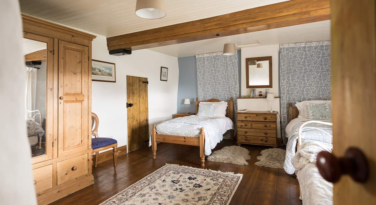 This spacious twin bedroom has a secret through the door...