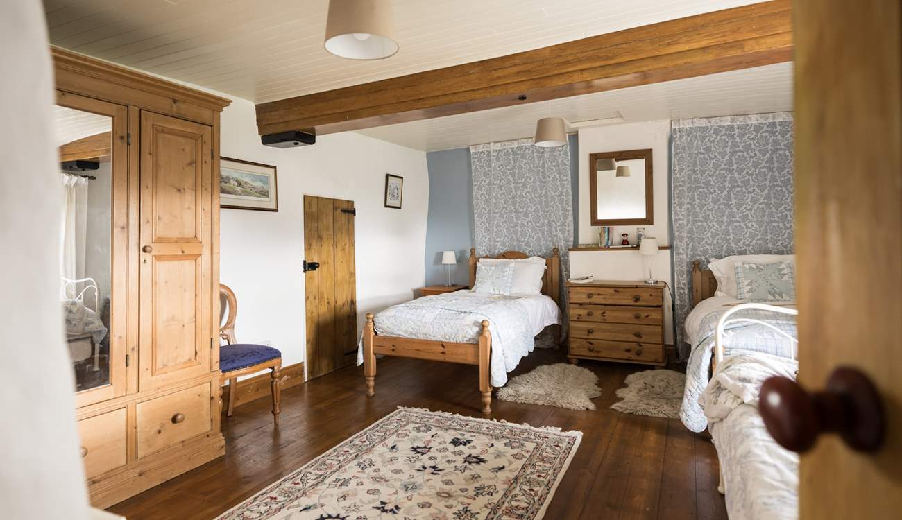 This spacious twin bedroom has a secret through the door...