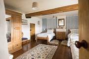 This spacious twin bedroom has a secret through the door...