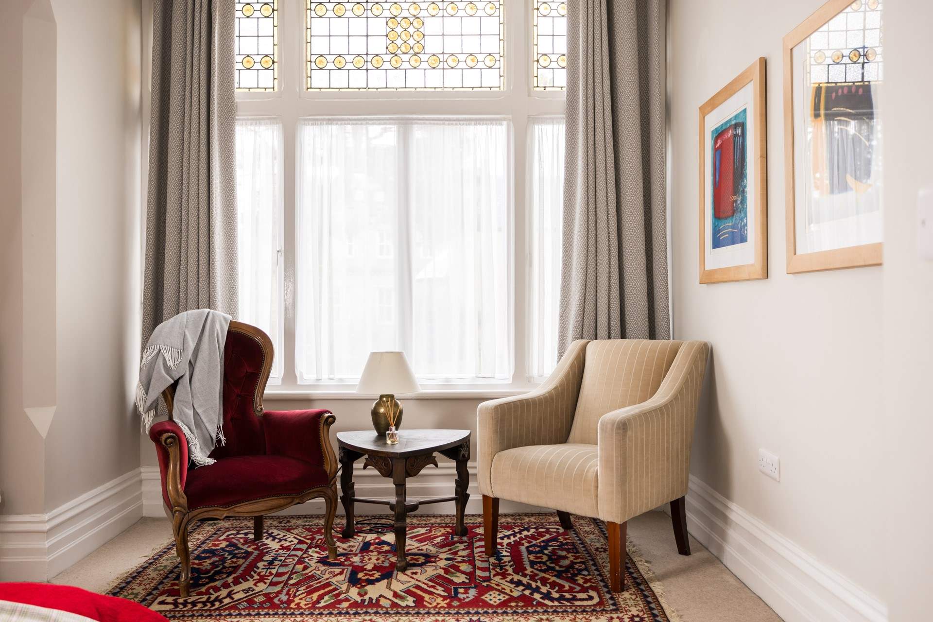 Original stained glass windows grace the king-size bedroom.