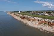 The iconic red and white stripe cliffs of Hunstanton with lighthouse.