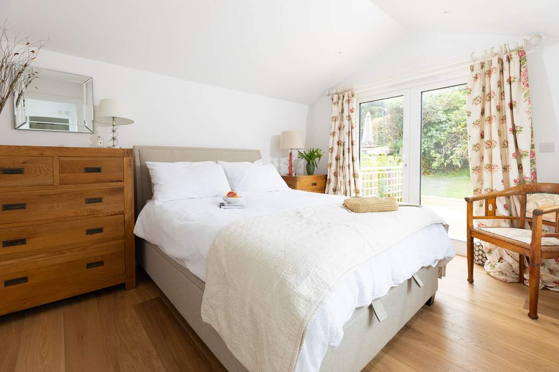 Bedroom 4 has patio doors onto the deck which leads into the pretty garden.