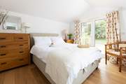 Bedroom 4 has patio doors onto the deck which leads into the pretty garden.