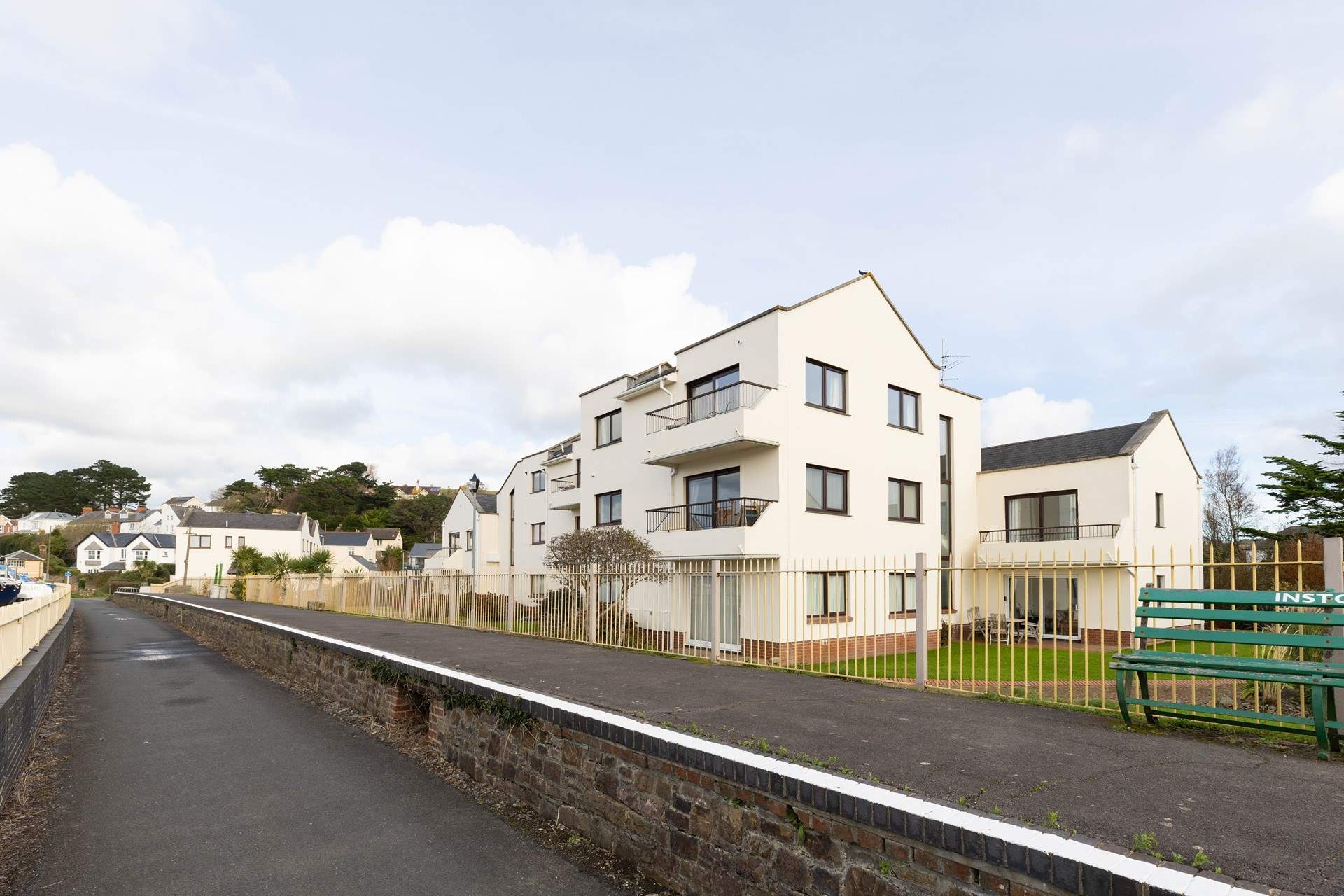 The apartment sits at the top of the block with communal gardens to the side.