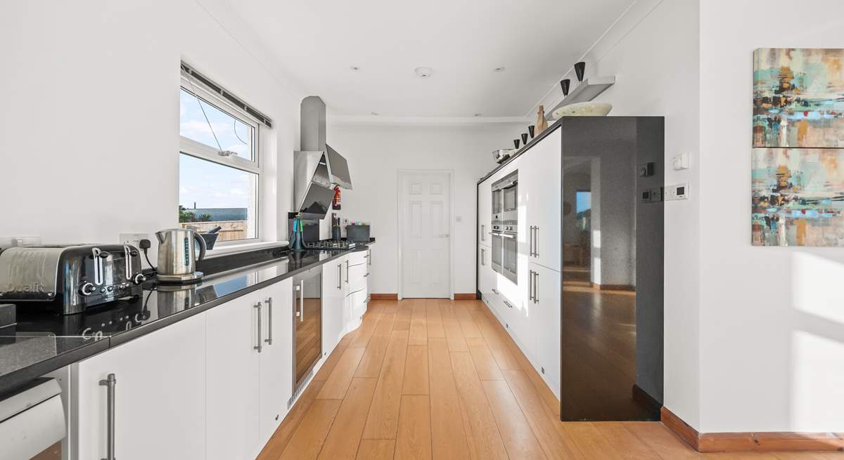 The kitchen leads into a rather large and handy utility-room.